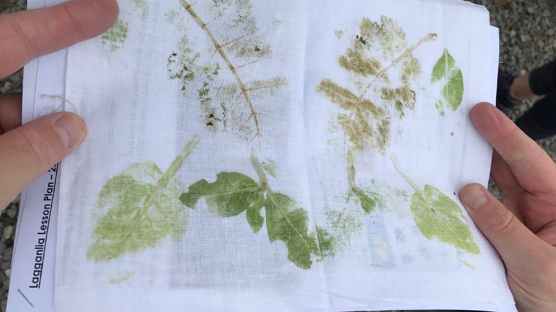 Creating leaf prints during the mini-lessons at Lagganlia image showing hands holding paper and material with printed leaves